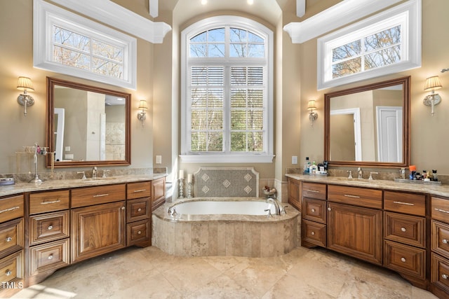 bathroom with vanity, a towering ceiling, and a wealth of natural light