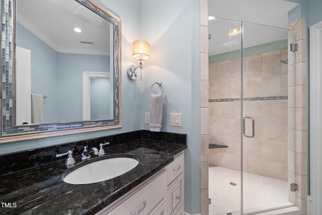 bathroom with an enclosed shower, vanity, and crown molding