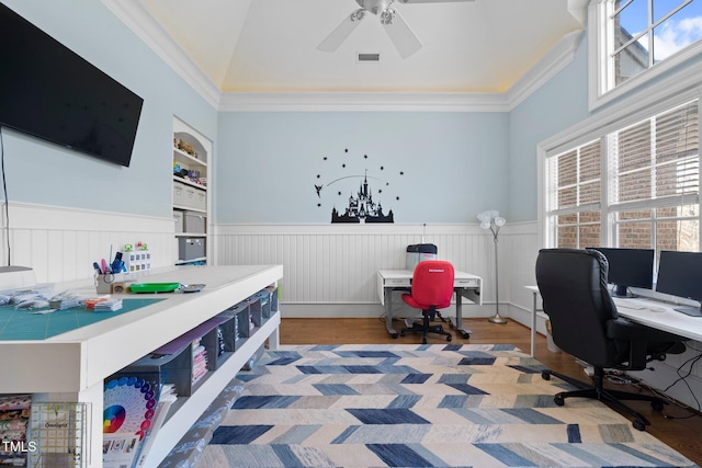 home office with hardwood / wood-style flooring, ornamental molding, plenty of natural light, and built in shelves