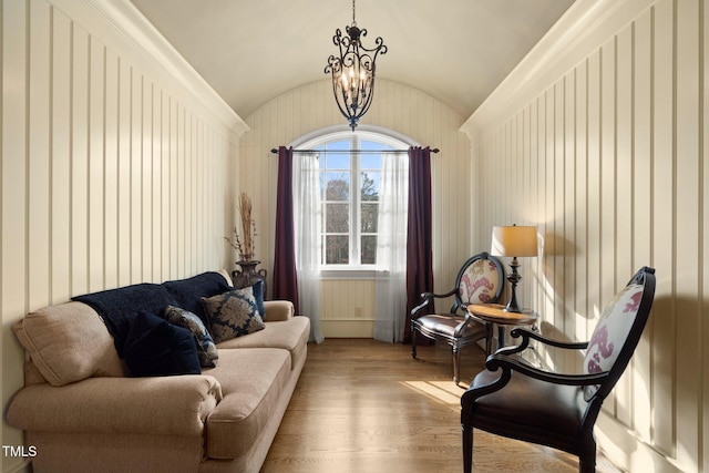 sitting room with vaulted ceiling, a notable chandelier, and light hardwood / wood-style flooring