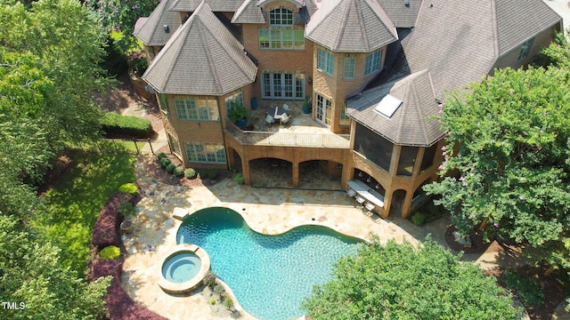 view of pool featuring an in ground hot tub and a patio