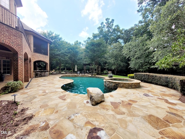 view of pool featuring an in ground hot tub and a patio area