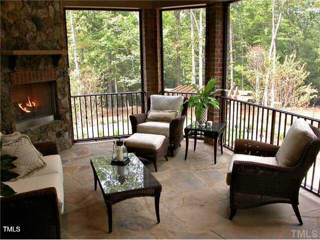 sunroom / solarium featuring an outdoor stone fireplace