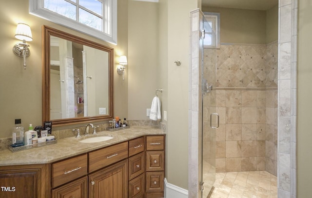 bathroom with a shower with door and vanity