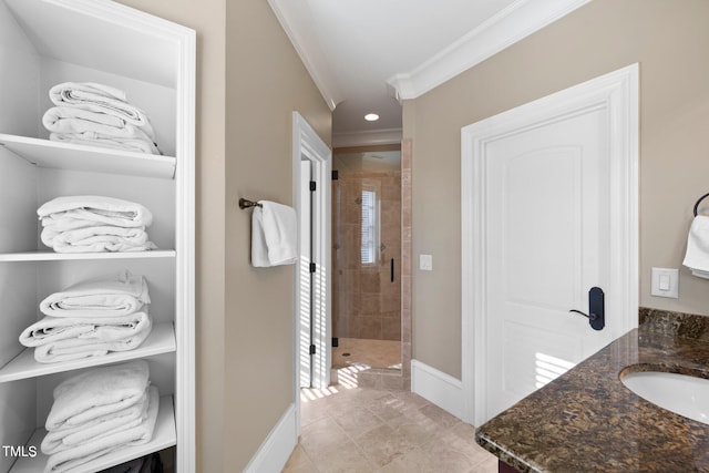 bathroom with walk in shower, vanity, and crown molding