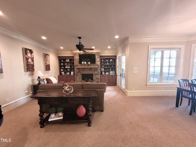 rec room featuring ornamental molding, light colored carpet, built in features, and a fireplace