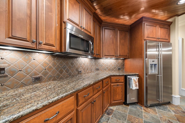 kitchen with dark stone countertops, tasteful backsplash, stainless steel appliances, and wooden ceiling