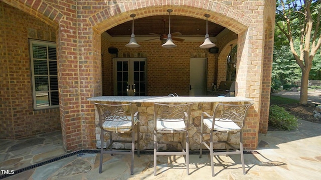 view of patio featuring grilling area, ceiling fan, and a bar