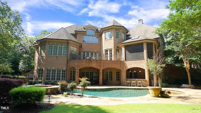 back of property with a patio and a balcony