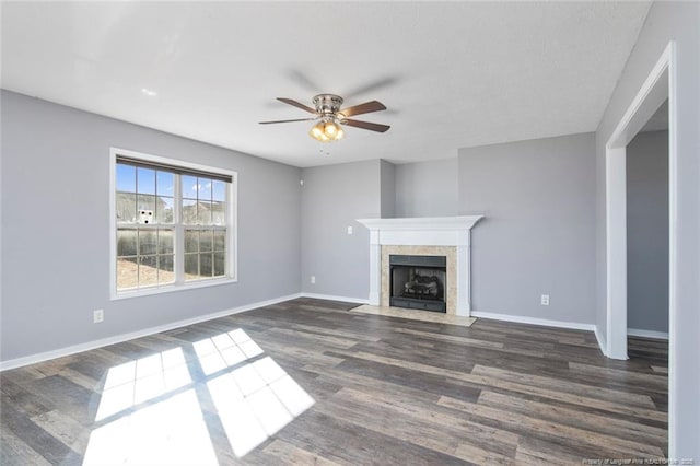 unfurnished living room with dark wood-type flooring and ceiling fan