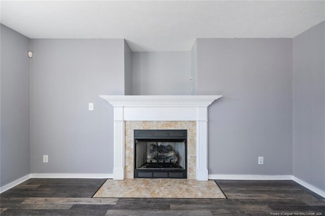 interior details with hardwood / wood-style flooring and a tile fireplace