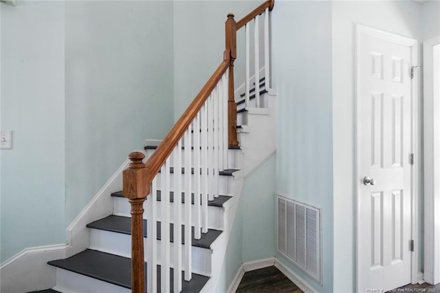 staircase featuring wood-type flooring