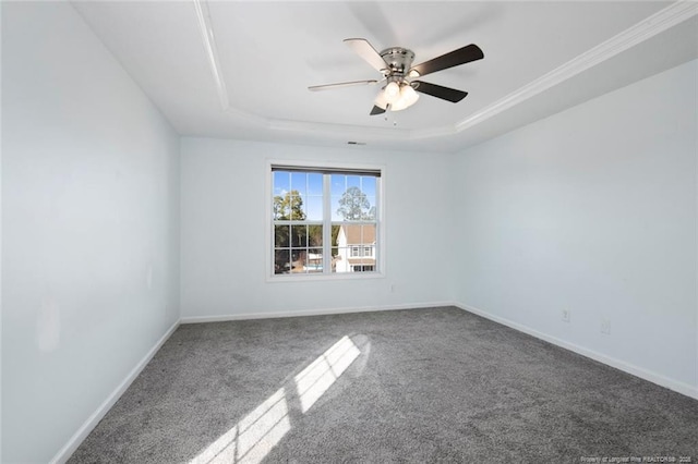 unfurnished room with crown molding, a tray ceiling, carpet floors, and ceiling fan