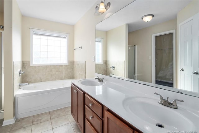 bathroom featuring tile patterned flooring, vanity, and plus walk in shower