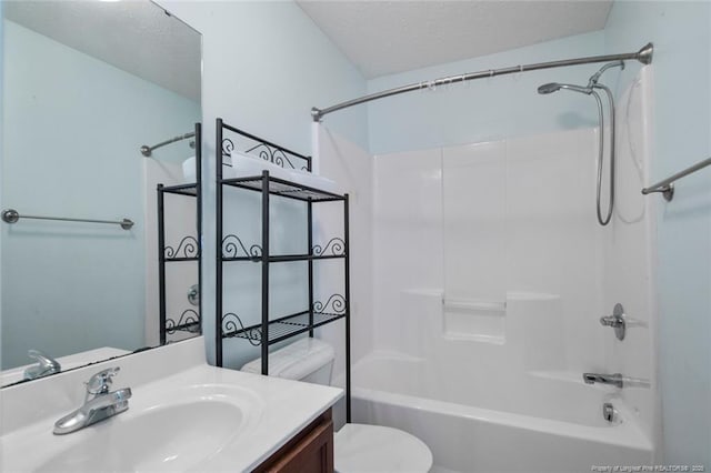 full bathroom featuring vanity, toilet, bathing tub / shower combination, and a textured ceiling