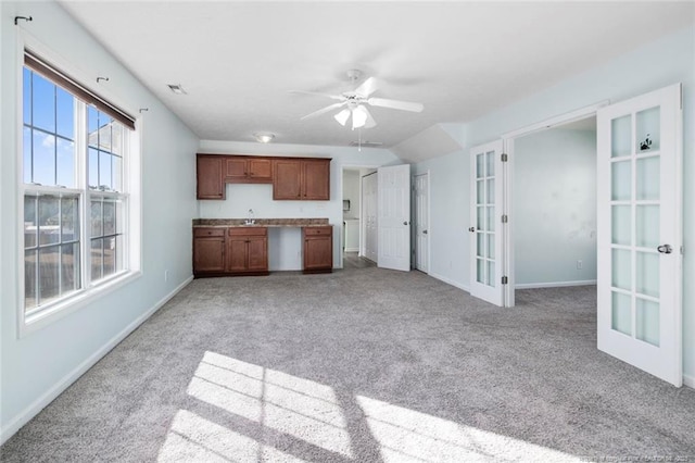 kitchen with french doors, ceiling fan, sink, and light carpet