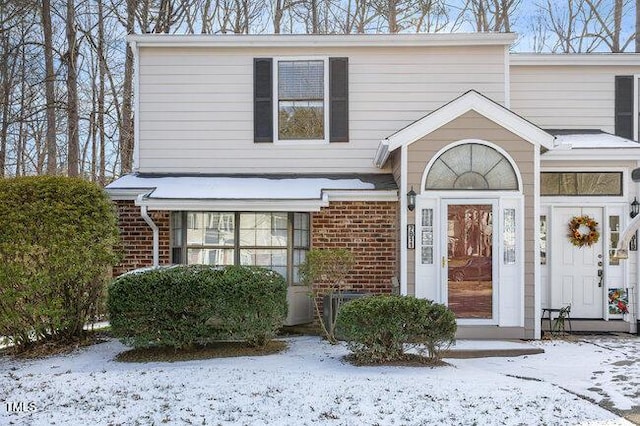 view of snow covered property entrance