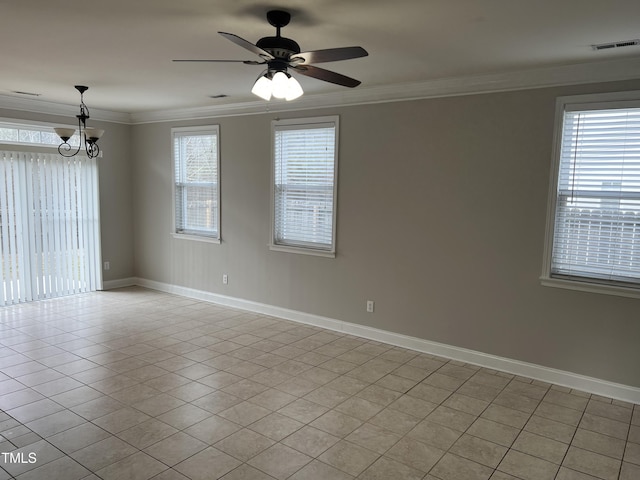 spare room with light tile patterned floors, crown molding, and plenty of natural light