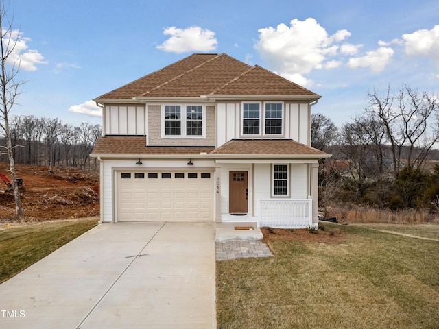 view of front facade with a garage, a front yard, and a porch