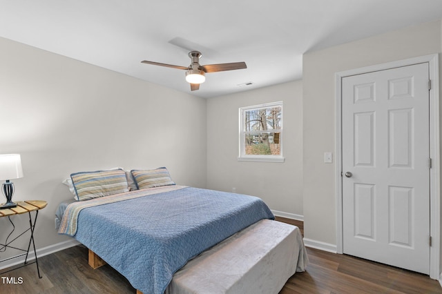 bedroom with dark hardwood / wood-style floors and ceiling fan