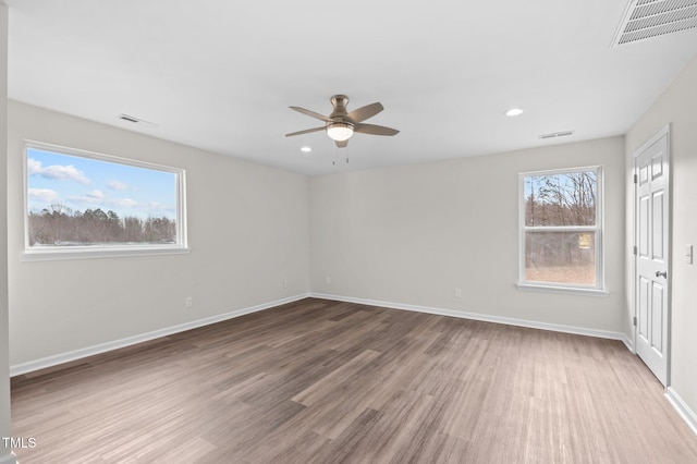 spare room with hardwood / wood-style floors and ceiling fan