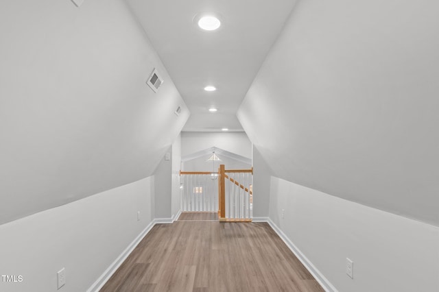 bonus room with lofted ceiling and light hardwood / wood-style flooring