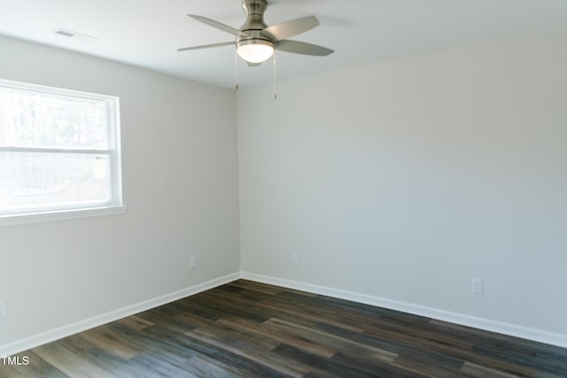 spare room with dark hardwood / wood-style flooring and ceiling fan