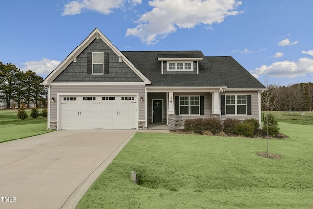 craftsman-style house featuring a garage and a front yard