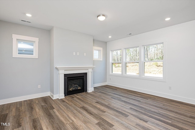 unfurnished living room with dark wood-type flooring