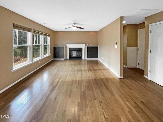 unfurnished living room with ceiling fan and light wood-type flooring