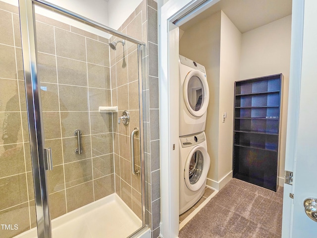 washroom with tile patterned flooring and stacked washing maching and dryer