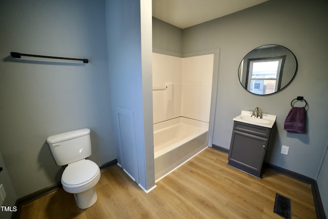 full bathroom featuring vanity, hardwood / wood-style floors, tub / shower combination, and toilet