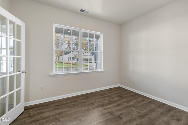 spare room featuring dark hardwood / wood-style flooring