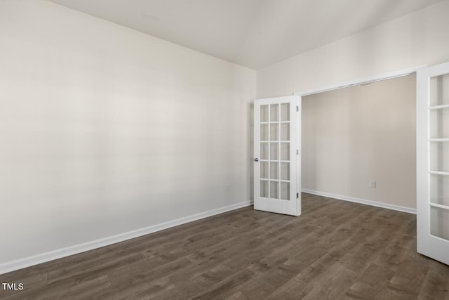 unfurnished room with french doors and dark hardwood / wood-style flooring