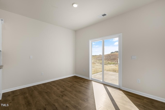 empty room with dark wood-type flooring