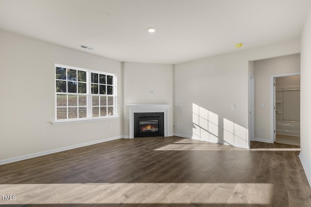 unfurnished living room featuring dark hardwood / wood-style flooring