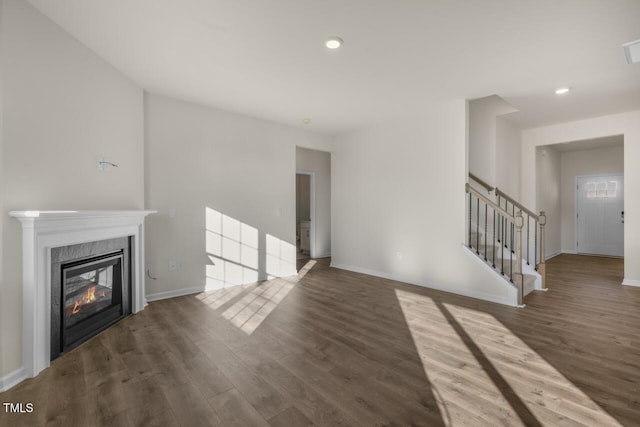 unfurnished living room featuring dark hardwood / wood-style floors