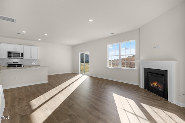 unfurnished living room featuring dark hardwood / wood-style floors