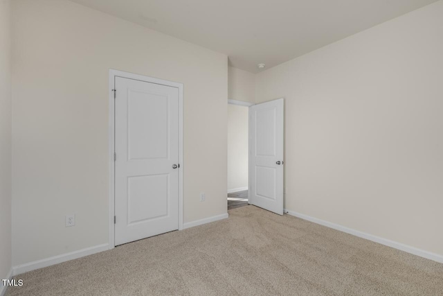 empty room featuring light colored carpet