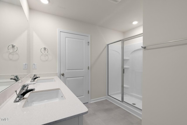 bathroom featuring vanity and a shower with door