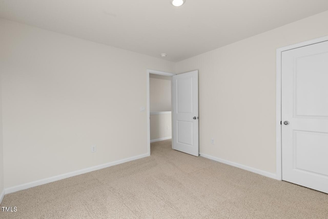 unfurnished bedroom with light colored carpet