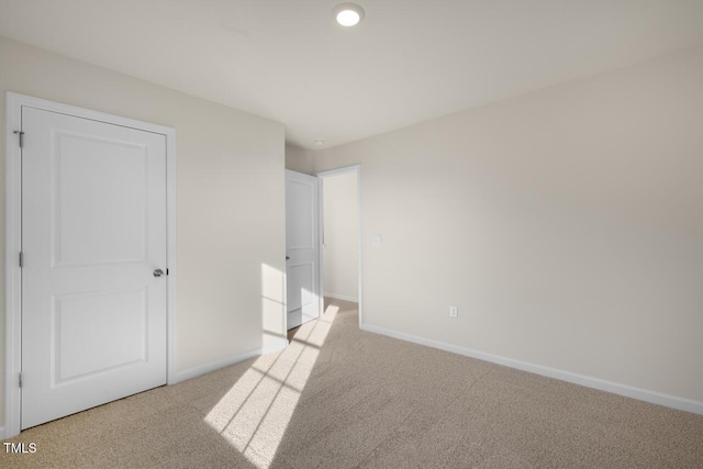 unfurnished bedroom with light colored carpet