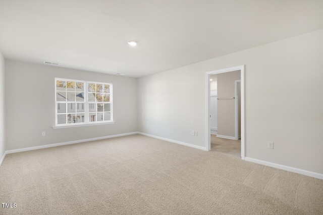 unfurnished room with light colored carpet