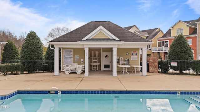 view of swimming pool with an outbuilding and a patio