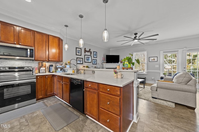 kitchen with sink, crown molding, appliances with stainless steel finishes, decorative light fixtures, and kitchen peninsula