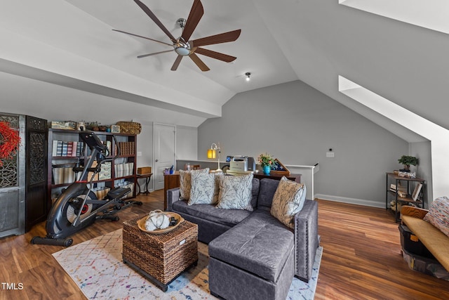 living room with wood-type flooring, lofted ceiling with skylight, and ceiling fan