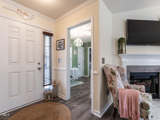 entryway with dark wood-type flooring, a textured ceiling, and plenty of natural light