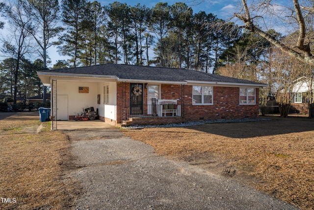 ranch-style home featuring a carport