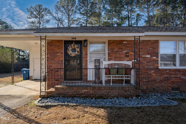 view of front of property featuring a carport and a porch