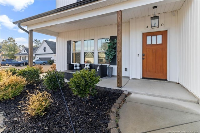 view of exterior entry featuring a porch